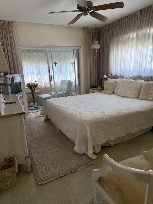carpeted bedroom with access to outside and ceiling fan