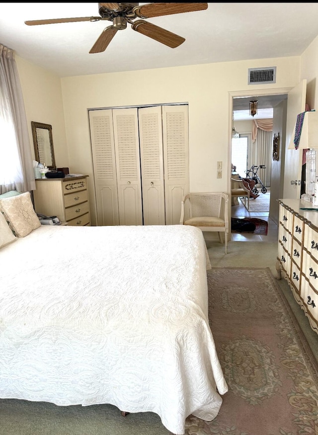 bedroom with a ceiling fan, a closet, carpet, and visible vents