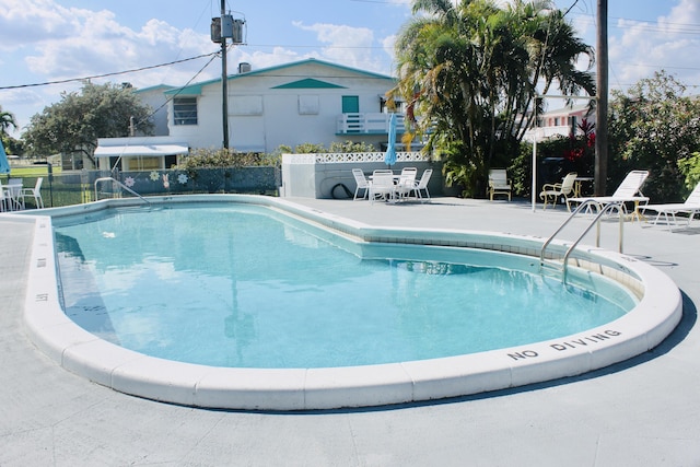 pool featuring a patio and fence