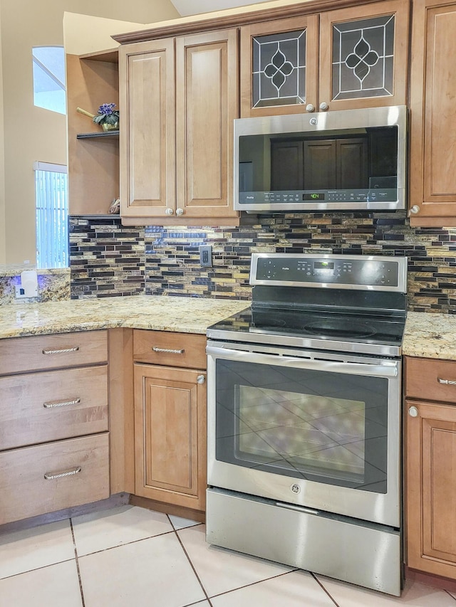 12404 Lakeridge Falls Dr, Boynton Beach, FL 33437 - kitchen featuring light stone counters, open shelves, decorative backsplash, light tile patterned flooring, and appliances with stainless steel finishes