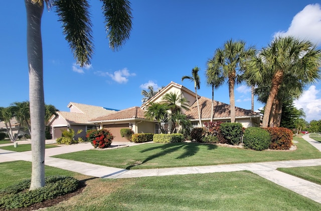 12404 Lakeridge Falls Dr, Boynton Beach, FL 33437 - view of front of house with stucco siding, a front lawn, driveway, and a tile roof