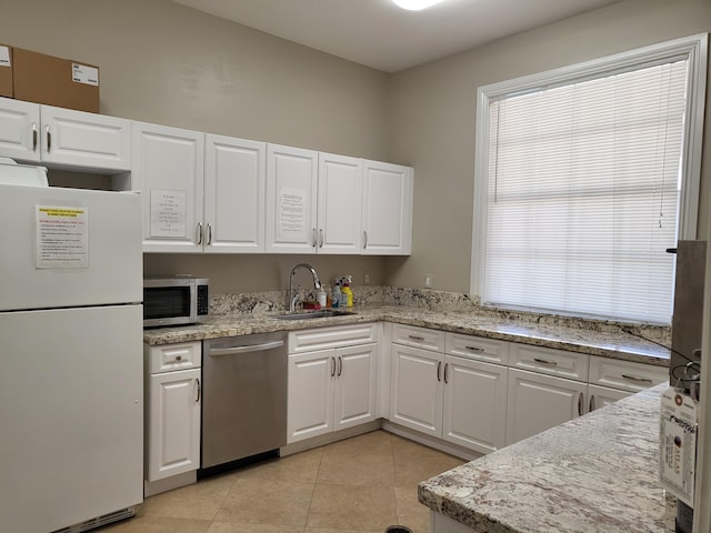 12404 Lakeridge Falls Dr, Boynton Beach, FL 33437 - kitchen with a sink, white cabinetry, appliances with stainless steel finishes, light stone countertops, and light tile patterned floors