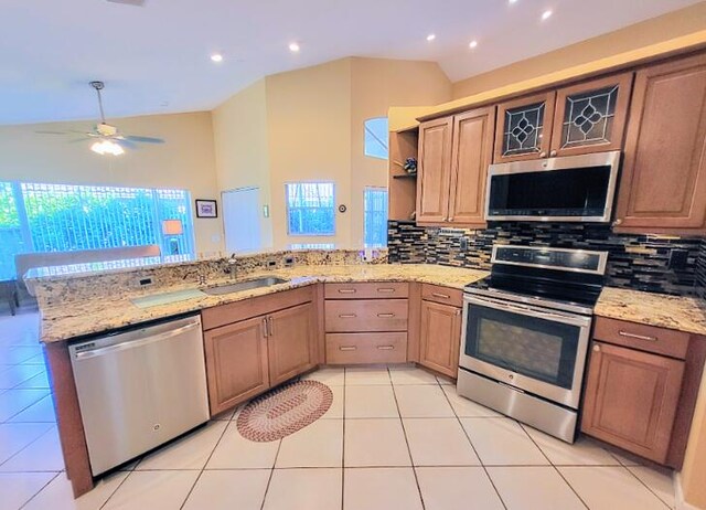 12404 Lakeridge Falls Dr, Boynton Beach, FL 33437 - kitchen featuring a peninsula, a sink, backsplash, lofted ceiling, and appliances with stainless steel finishes