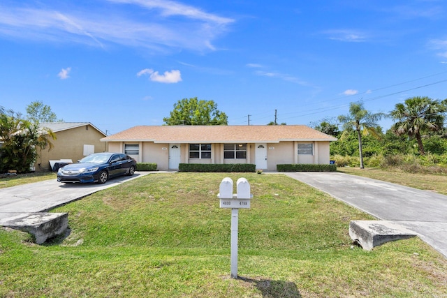single story home featuring stucco siding, a front yard, and concrete driveway