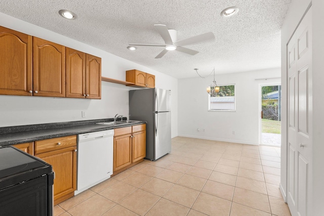kitchen with brown cabinets, ceiling fan, dark countertops, dishwasher, and black range with electric cooktop