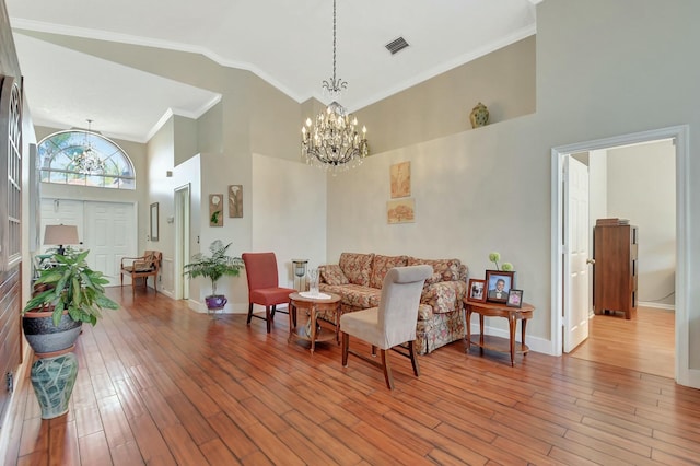 6090 Newport Village Way, Lake Worth, FL 33463 - living area featuring high vaulted ceiling, a notable chandelier, visible vents, and wood finished floors