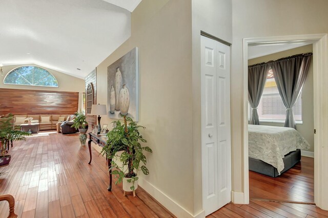 6090 Newport Village Way, Lake Worth, FL 33463 - hallway featuring baseboards, plenty of natural light, hardwood / wood-style floors, and lofted ceiling