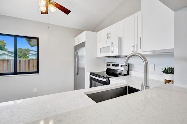5680 Northpointe Ln, Boynton Beach, FL 33437 - kitchen with ceiling fan, light stone countertops, stainless steel appliances, and white cabinetry