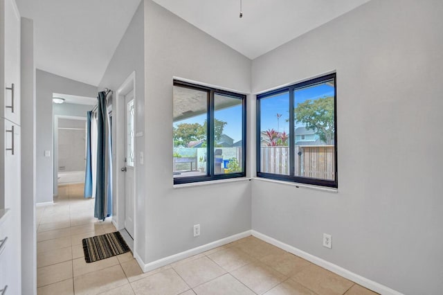 5680 Northpointe Ln, Boynton Beach, FL 33437 - empty room featuring baseboards, light tile patterned floors, and vaulted ceiling