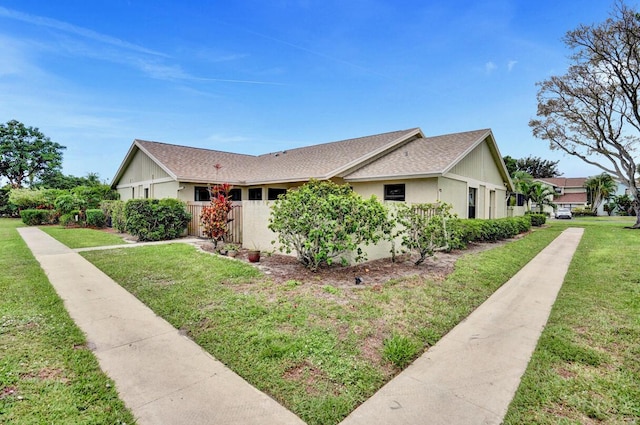 5680 Northpointe Ln, Boynton Beach, FL 33437 - view of property exterior with roof with shingles and a yard
