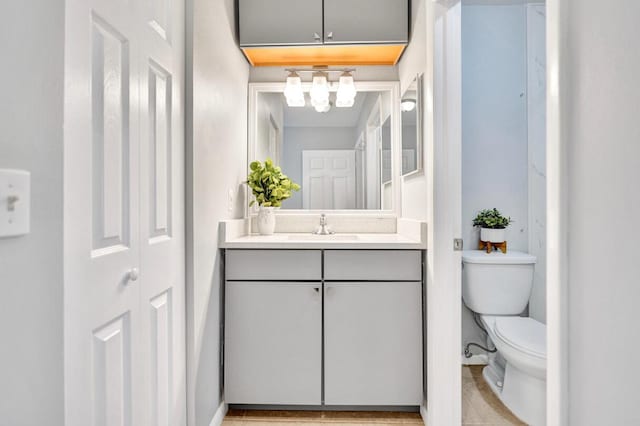 5680 Northpointe Ln, Boynton Beach, FL 33437 - bathroom with toilet, a notable chandelier, and vanity