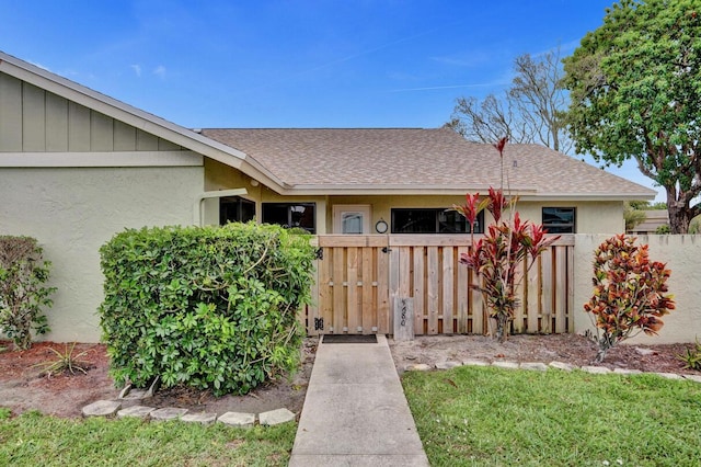 5680 Northpointe Ln, Boynton Beach, FL 33437 - view of front of property with stucco siding, roof with shingles, and fence