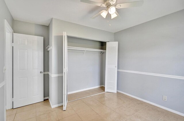 5680 Northpointe Ln, Boynton Beach, FL 33437 - unfurnished bedroom with baseboards, ceiling fan, light tile patterned floors, and a closet