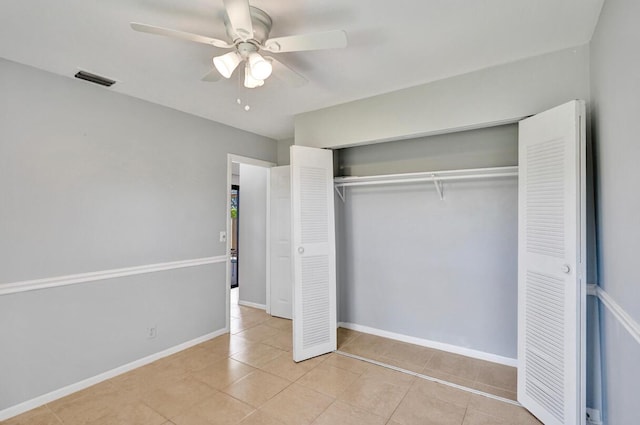 5680 Northpointe Ln, Boynton Beach, FL 33437 - unfurnished bedroom with a ceiling fan, visible vents, tile patterned floors, baseboards, and a closet