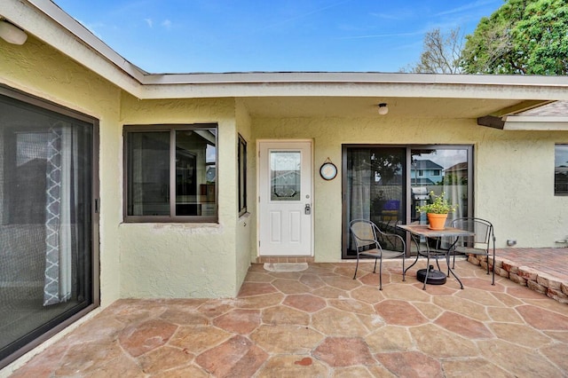 5680 Northpointe Ln, Boynton Beach, FL 33437 - doorway to property with a patio area and stucco siding