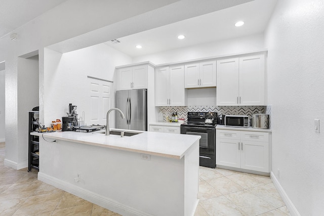 600 NW 24th Ave, Boynton Beach, FL 33426 - kitchen featuring appliances with stainless steel finishes, backsplash, white cabinetry, a sink, and baseboards