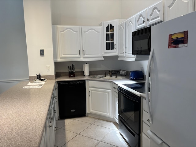 1801 S US Highway 1 Unit 12B, Jupiter, FL 33477 - kitchen with black appliances, a sink, white cabinetry, and glass insert cabinets