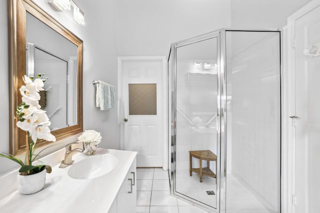 full bathroom featuring vanity, tile patterned floors, and a stall shower