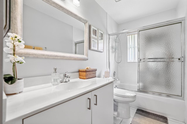 full bathroom with vanity, shower / bath combination with glass door, and toilet