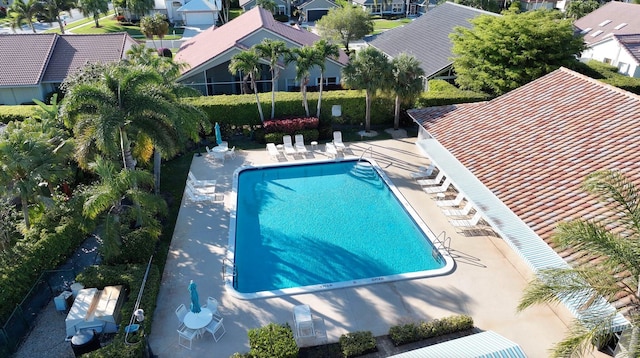 pool featuring a patio area and a residential view