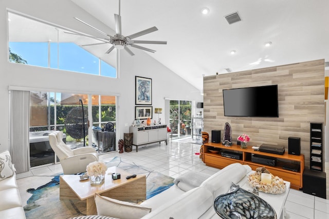living room featuring a wealth of natural light, a ceiling fan, high vaulted ceiling, and visible vents