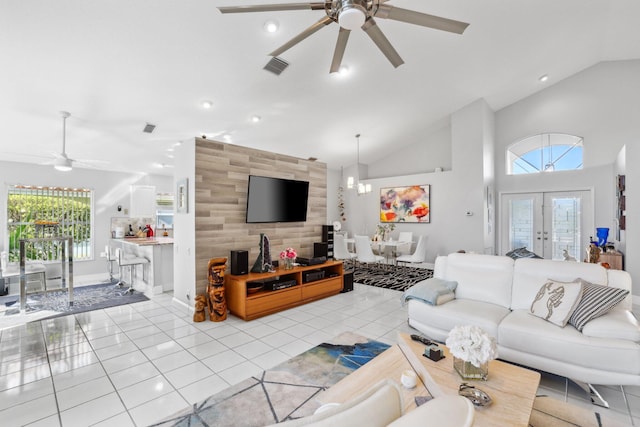 living area with lofted ceiling, visible vents, a ceiling fan, french doors, and light tile patterned floors