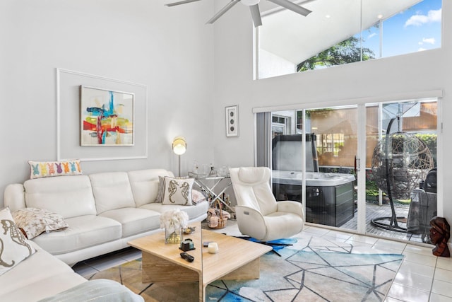living area featuring tile patterned floors, high vaulted ceiling, and ceiling fan