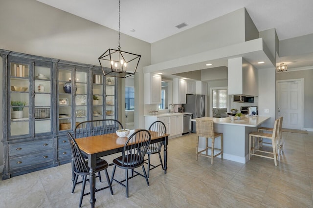 dining space with baseboards, a notable chandelier, and visible vents