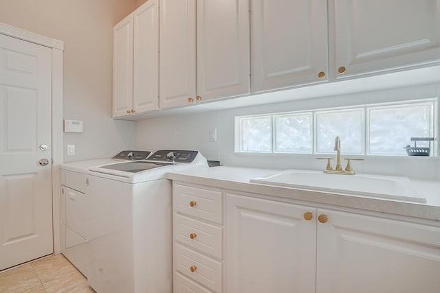 laundry area featuring a sink, cabinet space, and washer and dryer