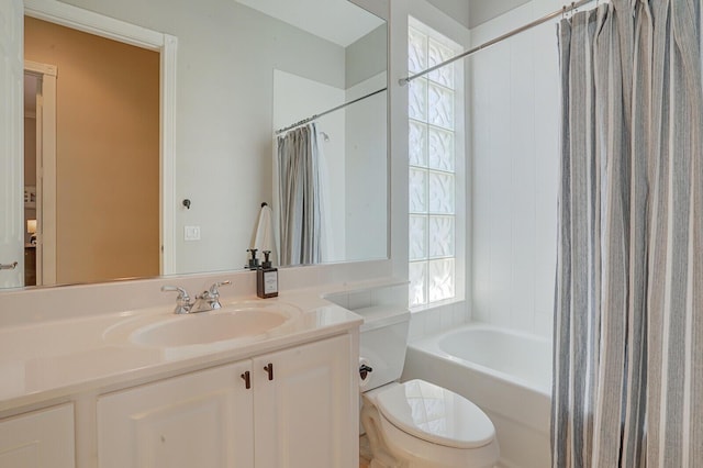 full bath featuring vanity, toilet, and shower / tub combo