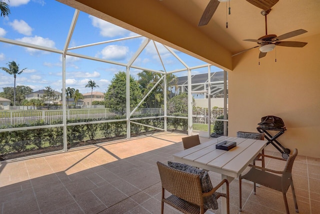 sunroom / solarium featuring a ceiling fan and outdoor dining area