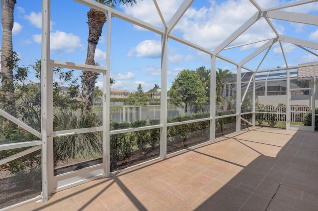 unfurnished sunroom featuring a water view