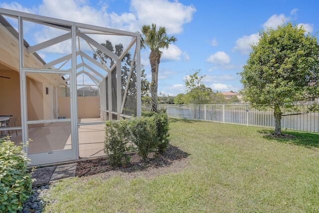 view of yard with a fenced backyard and glass enclosure