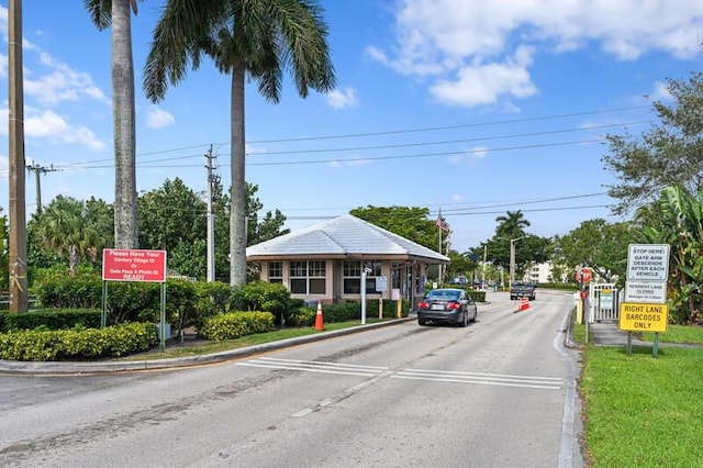 107 Sheffield E, West Palm Beach, FL 33417 - view of asphalt road with traffic signs, curbs, and street lighting