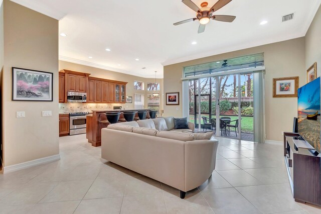 6722 Watertown Dr, Boynton Beach, FL 33437 - living room with ornamental molding, light tile patterned floors, a ceiling fan, and a healthy amount of sunlight