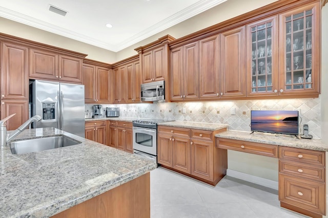 6722 Watertown Dr, Boynton Beach, FL 33437 - kitchen with light tile patterned floors, glass insert cabinets, light stone countertops, stainless steel appliances, and a sink