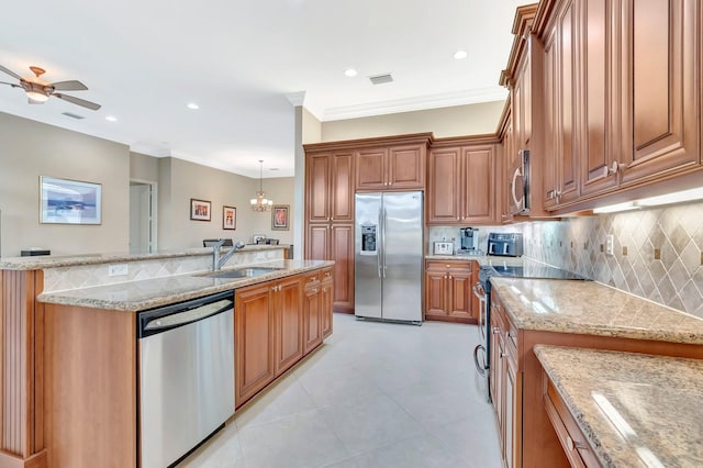 6722 Watertown Dr, Boynton Beach, FL 33437 - kitchen featuring appliances with stainless steel finishes, visible vents, brown cabinets, decorative backsplash, and a sink