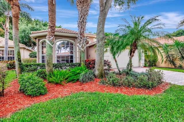 6722 Watertown Dr, Boynton Beach, FL 33437 - mediterranean / spanish-style house featuring a tiled roof, driveway, stucco siding, and a garage