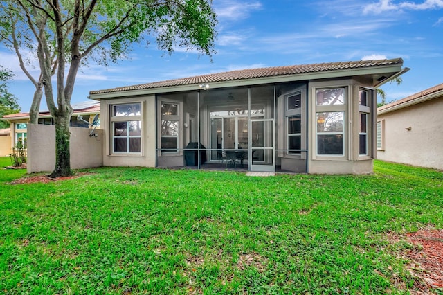 6722 Watertown Dr, Boynton Beach, FL 33437 - back of house with a sunroom, a tiled roof, stucco siding, and a yard