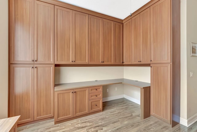 6722 Watertown Dr, Boynton Beach, FL 33437 - unfurnished office featuring light wood-style floors, built in desk, and baseboards