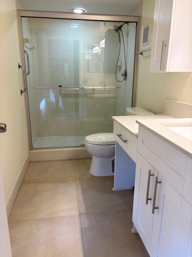 full bath featuring toilet, tile patterned floors, vanity, and a shower stall