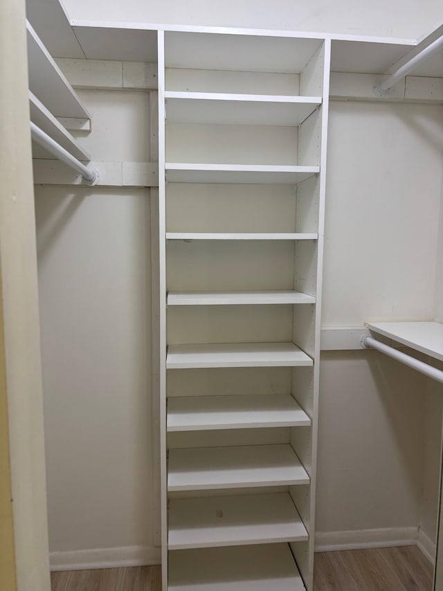 walk in closet featuring wood finished floors