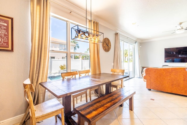 dining room with crown molding, light tile patterned floors, and ceiling fan