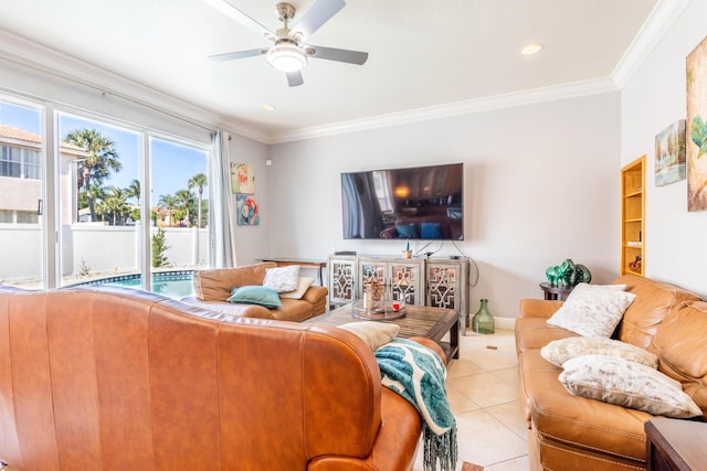 living room featuring light tile patterned floors, baseboards, a ceiling fan, and ornamental molding