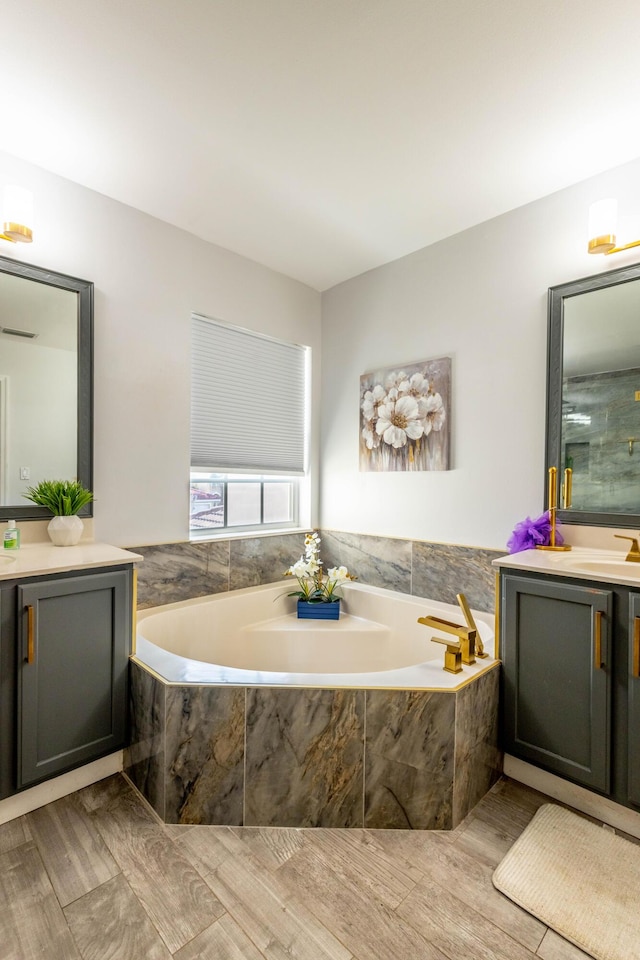 bathroom featuring vanity and a garden tub