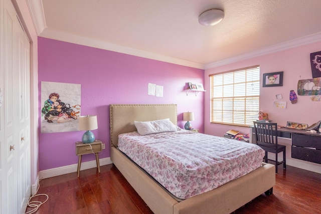 bedroom featuring crown molding, wood finished floors, and baseboards