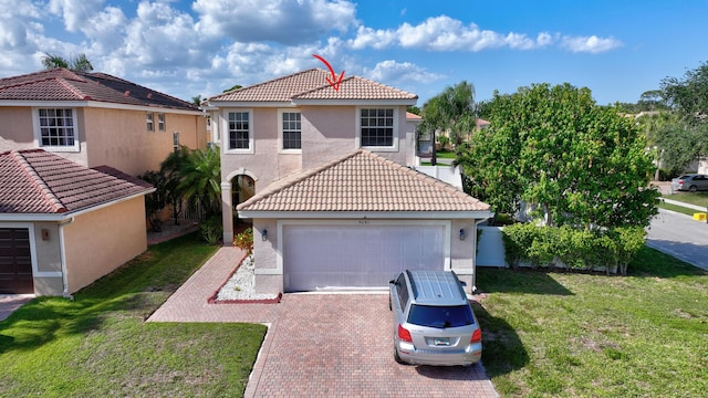 view of front facade with a front yard, a garage, a tile roof, stucco siding, and decorative driveway