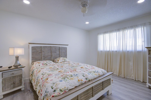 11 Colonial Club Dr Unit 302, Boynton Beach, FL 33435 - bedroom with recessed lighting, baseboards, ceiling fan, a textured ceiling, and light wood-style floors