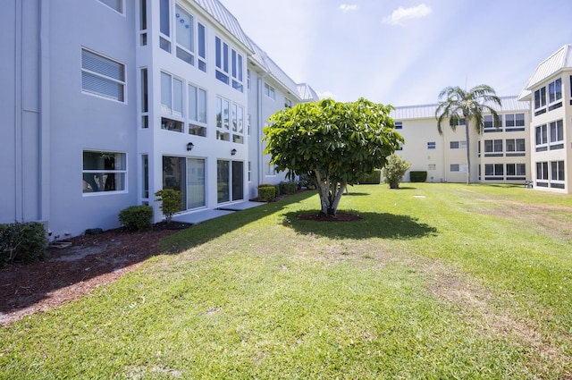 11 Colonial Club Dr Unit 302, Boynton Beach, FL 33435 - surrounding community with a yard