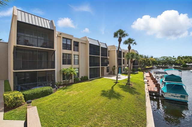 view of dock featuring a lawn
